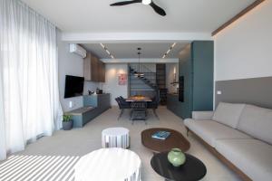 a living room with a couch and a table at Zoe Sea View Villas in Paleros
