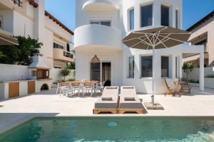 a villa with a swimming pool and a house at Villa Rhodea in Ialysos