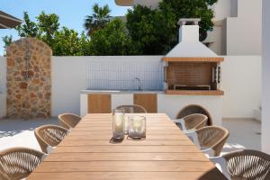 a wooden table with glasses on top of a patio at Villa Rhodea in Ialysos +35 photos