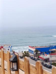 a view of the beach from a wooden fence at Ifni Flow Seafront surfhouse in Sidi Ifni