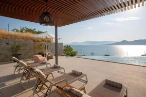 a patio with a view of the water at Zoe Sea View Villas in Paleros