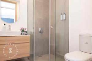 a bathroom with a shower with a toilet and a sink at Top Rentals EpiQ in Quito +30 photos