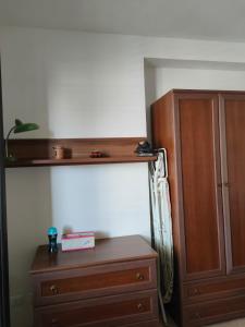 a bedroom with a wooden cabinet and a dresser at Villa Cristina in Triscina +3 photos