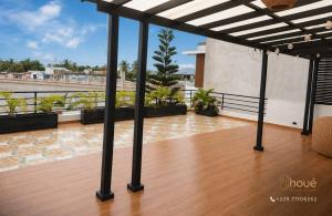 a balcony with a wooden floor and a view of the water at Résidence Houé 