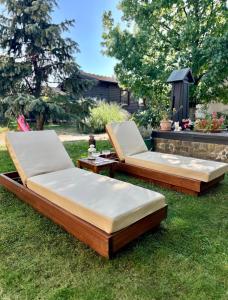 two beds sitting on the grass in a yard at Apartment Kala in Varaždin