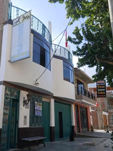 a building with a sign on the side of it at Hospedaje Vicente in Lunahuaná