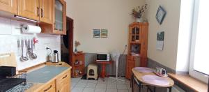 a kitchen with a counter and a table in it at Kawalerka u Megi in Borne Sulinowo