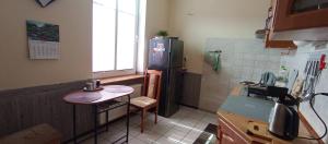 a kitchen with a small table and a refrigerator at Kawalerka u Megi in Borne Sulinowo +17 photos