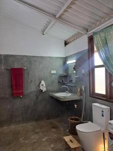 a bathroom with a toilet and a sink at Nature Kingdom Sri Lanka in Hambegamuwa +154 photos