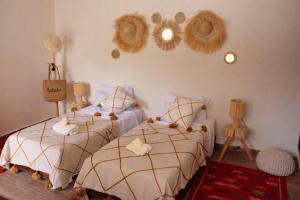 a bedroom with two beds and a mirror on the wall at Villa Dar Nata Marrakech in El Mers +26 photos
