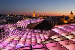 a view of a building with purple lights on it at Las Nubes Mairena in Mairena del Aljarafe