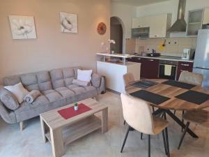 a living room and kitchen with a couch and a table at More in Rab +14 photos