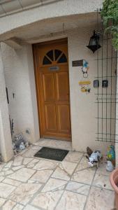 a door of a house with stuffed animals in front of it at Le petit cocon in Linas