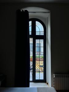 an open door to a room with a window at BS Studios in Baku