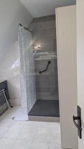 a shower with a shower curtain in a bathroom at Le petit cocon in Linas +1 photo
