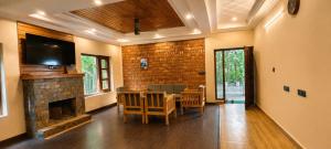a living room with a table and a fireplace at Summer Stays Boho in Bhīm Tāl