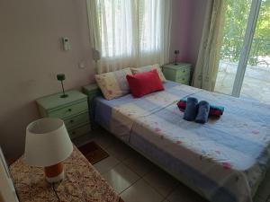 a bedroom with a bed with two pillows on it at Dimis apartments in Leptokarya