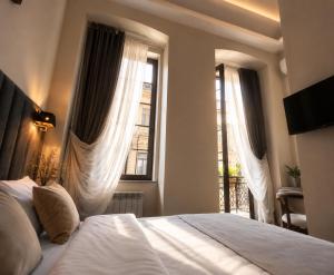 a bedroom with a bed and two windows at BS Studios in Baku