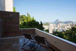 
a room with a balcony overlooking a city at Sugar Loft Apartments in Rio de Janeiro
