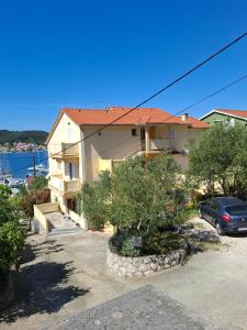 a house with a car parked in front of it at More in Rab