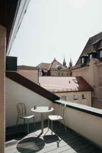 a balcony with two chairs and a table on a building at The Haus KAI Nuremberg in Nuremberg