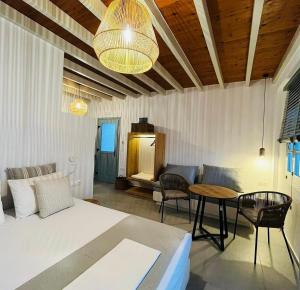 a living room with a couch and a table at Arhontiko Houses in Astypalaia