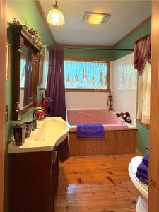 a bathroom with a tub and a sink at Blue Crystal Hideaway BnB in Eureka Springs +66 photos