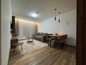 a living room with a couch and a table at Apartmani Pužić in Kopaonik