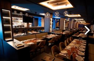 a dining room with long tables and chairs at Apartmani Pužić in Kopaonik
