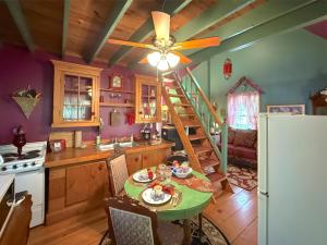 a kitchen with a table and a ceiling fan at Blue Crystal Hideaway BnB in Eureka Springs
