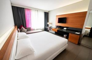 a hotel room with a large bed and a television at Cosmopolitan Hotel in Civitanova Marche +51 photos