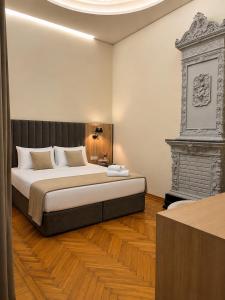 a bedroom with a large bed and a fireplace at BS Studios in Baku +17 photos
