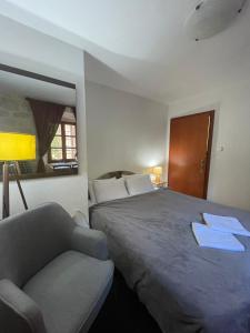 a bedroom with a bed and a couch and a chair at Villa Old Mariner in Kotor