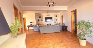 a living room with a couch and a table at Casas do Monte I - T3 