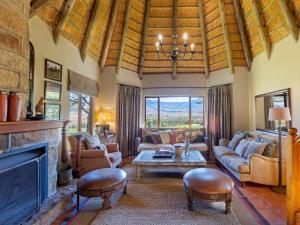 a living room filled with furniture and a fireplace at Montusi Self-Catering Cottages in Bergville