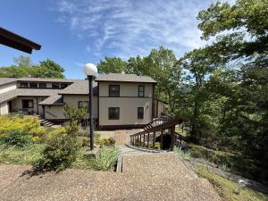 a large house with a bridge in front of it at The Treehouse on Table Rock in Eureka Springs
