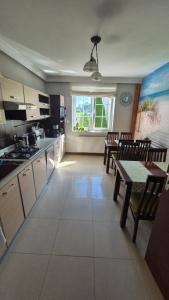 a kitchen with a table and chairs and a dining room at Villa Maritima in Grzybowo