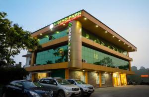a building with cars parked in front of it at GH Grand Park in Angamaly