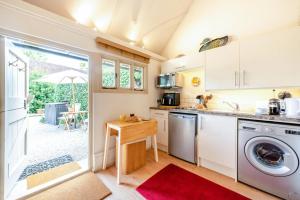 a kitchen with a washing machine and a table at 1 Bed in Battle oc-bt112 in Battle +23 photos