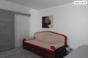 a room with a red bench in a room at villa Kanel in Le Robert
