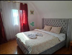 a bedroom with a large bed with a bow on it at L'Arche de Yves-Jody in Saint-Jean-de-Braye