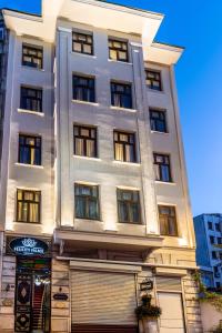 a tall white building with a garage at Felicity Palace Sirkeci in Istanbul