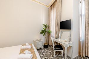 a hotel room with two beds and a desk at Felicity Palace Sirkeci in Istanbul +9 photos