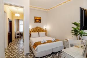 a bedroom with a bed and a desk and a mirror at Felicity Palace Sirkeci in Istanbul