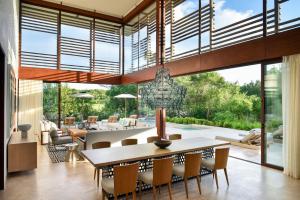 a dining room with a table and chairs at Rosewood Mayakoba in Playa del Carmen
