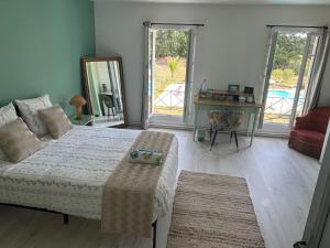 a bedroom with a bed and a table and a mirror at Sérénité in Saint-Vivien-de-Blaye +27 photos