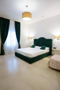 a bedroom with a large bed and a large window at Villa Natia in Mottola +37 photos