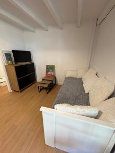 a bedroom with a bed and a flat screen tv at Appartement porteteni in Vieux-Boucau-les-Bains