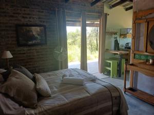 a bedroom with a bed with a laptop on it at BosSpoke Bush Lodge in Thabazimbi