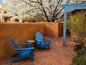 two blue chairs and a table on a brick patio at Las Brisas de Santa fe in Santa Fe +5 photos